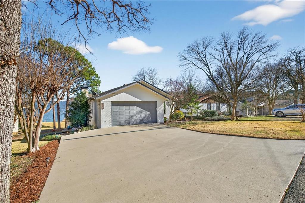 353 Winding Shore Tool, TX 75143 - Photo 33 of 35 a view of large house with a yard and large tree