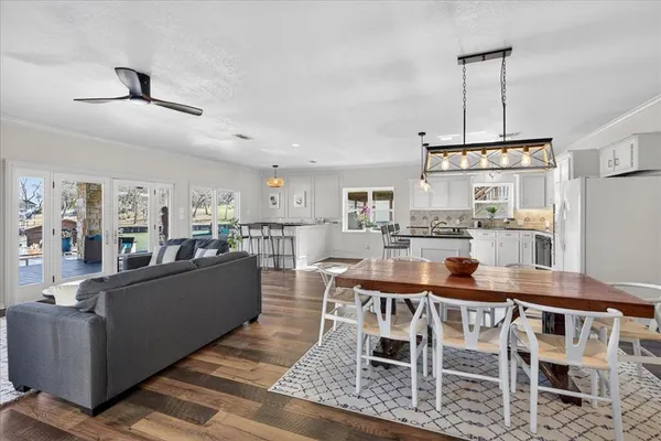 a dining room with furniture and wooden floor