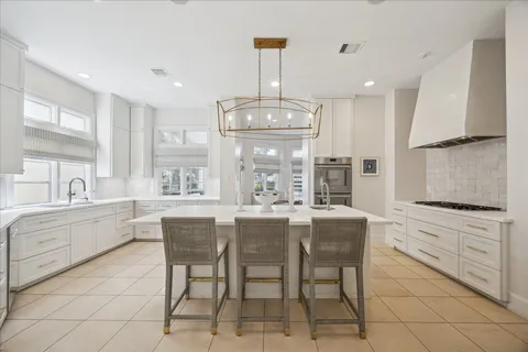 a kitchen with granite countertop cabinets a table and chairs in it