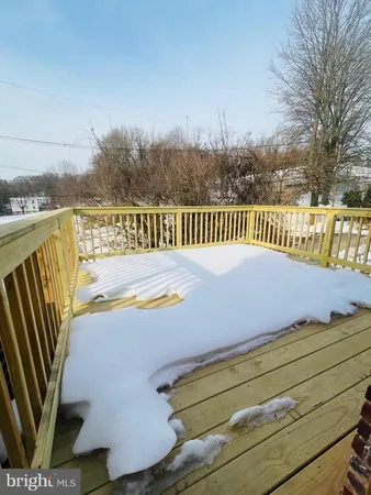 a view of balcony with wooden floor and fence