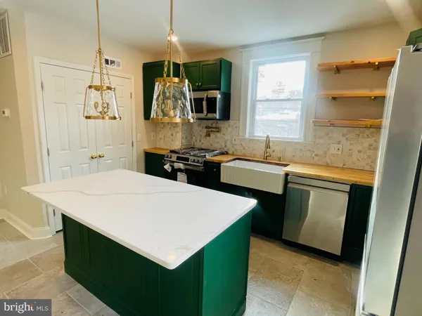 a view of a kitchen with a sink and a window