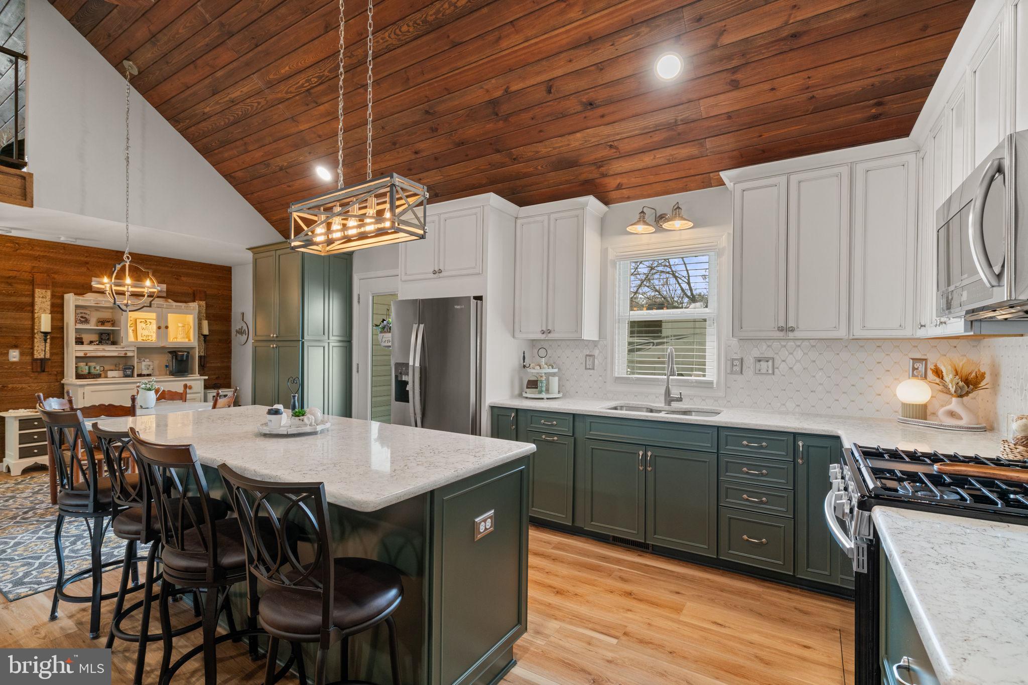 37 Pendleton Road Fredericksburg, VA 22405 - Photo 13 of 43 a kitchen with stainless steel appliances granite countertop a stove a refrigerator a kitchen island a dining table and chairs with wooden floor