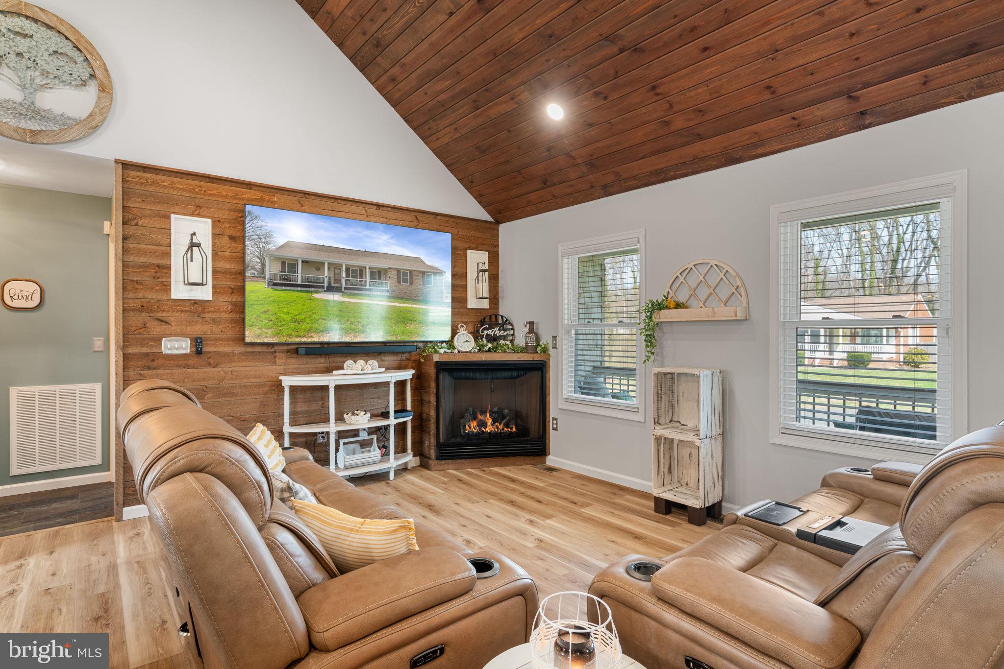 37 Pendleton Road Fredericksburg, VA 22405 - Photo 3 of 43 a living room with furniture a flat screen tv and a fireplace