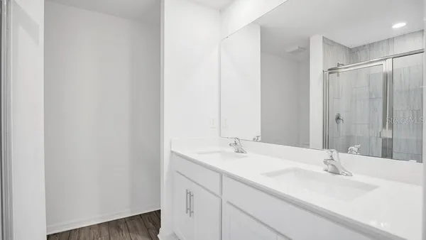 a bathroom with a double vanity sink and a mirror