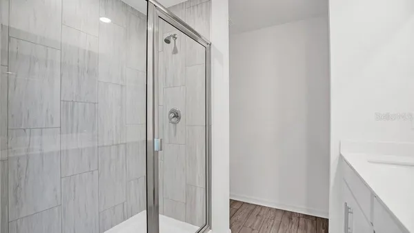 a bathroom with a shower and a sink