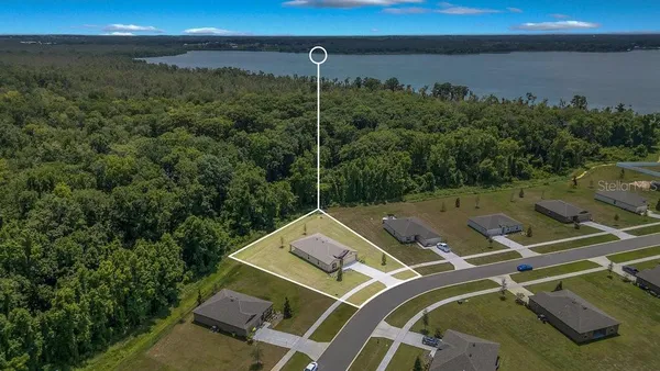 an aerial view of a house with a ocean view