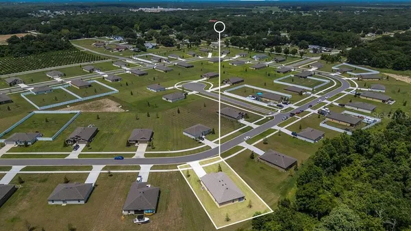 an aerial view of a house with a swimming pool