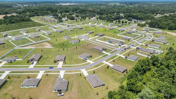 an aerial view of residential building and lake