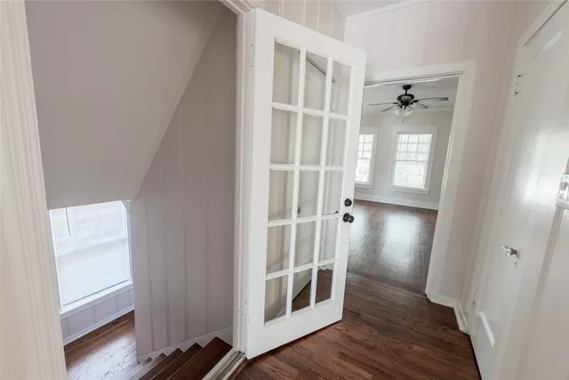 a view of a hallway with wooden floor and closet