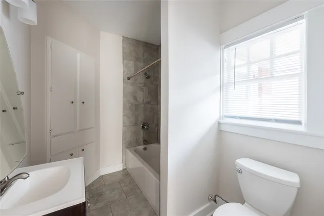 a bathroom with a toilet bathtub and sink