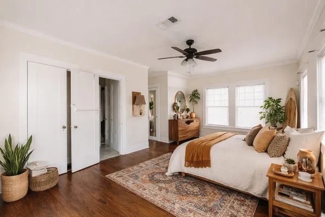 a bedroom with a bed and wooden floor