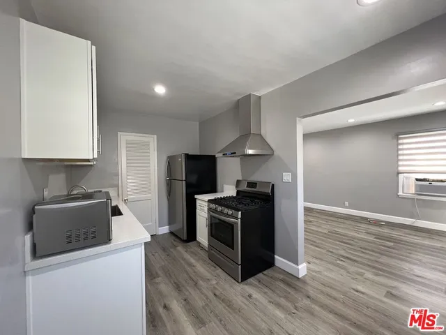 a kitchen with a sink a stove and refrigerator