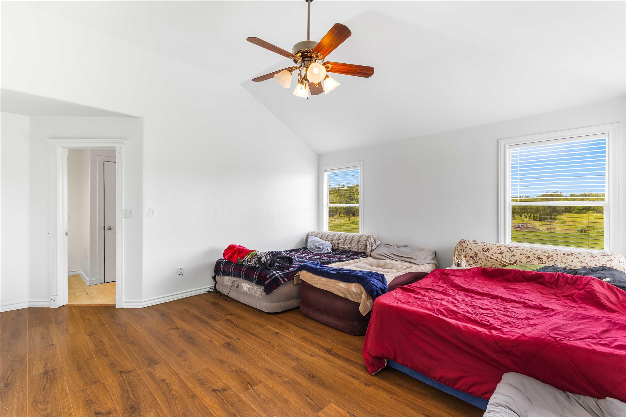 12212 Ballerstedt Road Elgin, TX 78621 - Photo 17 of 39 Bedroom with vaulted ceiling, wood finished floors, and ceiling fan