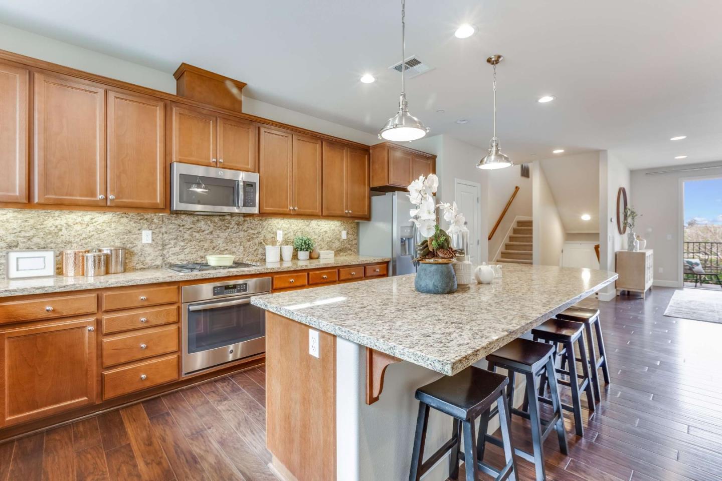 579 Holthouse Terrace Sunnyvale, CA 94087 - Photo 11 of 37 a kitchen with a table chairs sink and cabinets