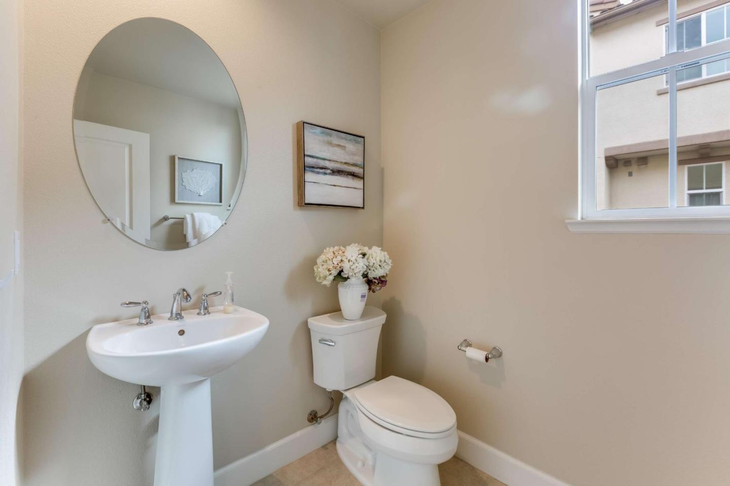 579 Holthouse Terrace Sunnyvale, CA 94087 - Photo 17 of 37 a bathroom with a toilet sink and mirror