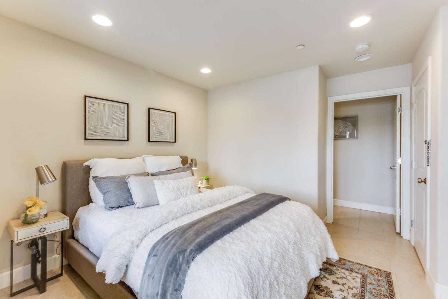 579 Holthouse Terrace Sunnyvale, CA 94087 - Photo 28 of 37 a bedroom with a bed and painting on the wall