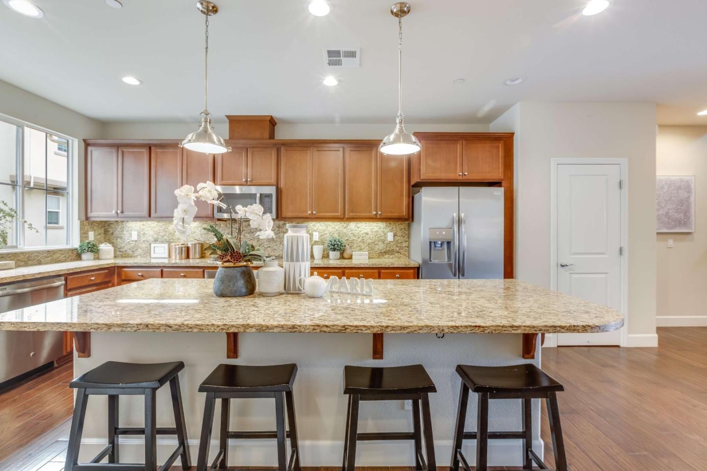 579 Holthouse Terrace Sunnyvale, CA 94087 - Photo 10 of 37 a kitchen with granite countertop a counter space and stainless steel appliances
