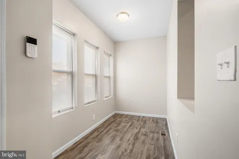 a view of a room with wooden floor and windows