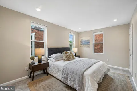 a bedroom with a bed a table and a window