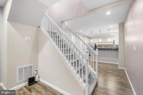 a view of kitchen with kitchen island a sink stainless steel appliances and cabinets