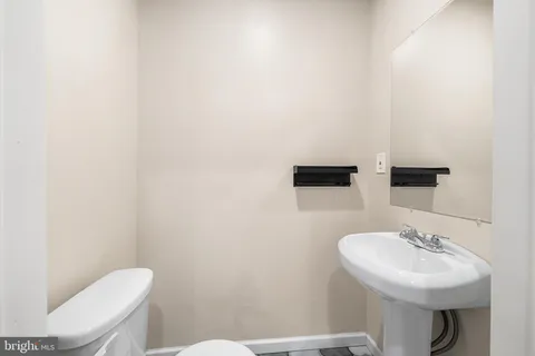 a view of kitchen with kitchen island stainless steel appliances sink and cabinets