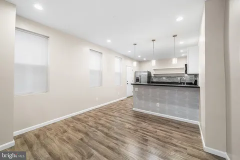 a kitchen with stainless steel appliances granite countertop a stove a refrigerator and a sink