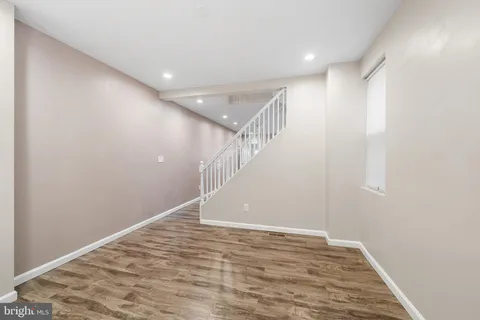 a kitchen with granite countertop white cabinets white stainless steel appliances and a sink
