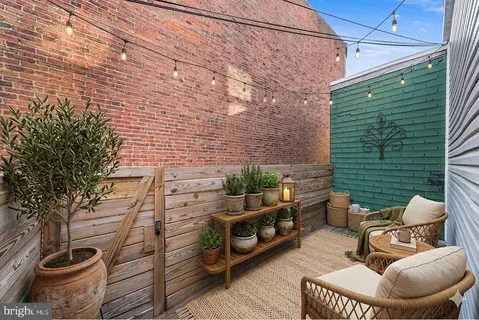 a view of a chairs and table in the back yard of the house