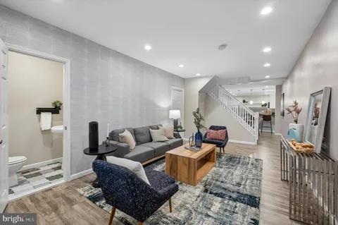 a living room with furniture and a wooden floor