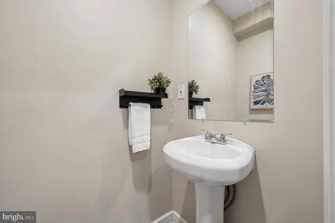 a bathroom with a sink and mirror