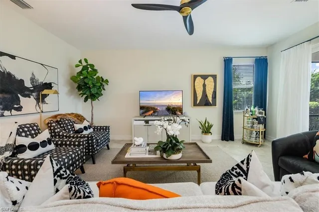 a living room with furniture and a potted plant