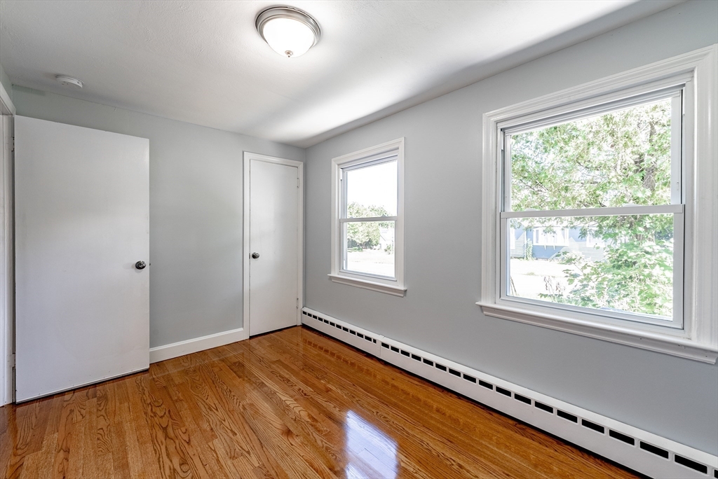 126 Lancaster Avenue West Springfield, MA 01089 - Photo 13 of 35 a view of an empty room with wooden floor and a window