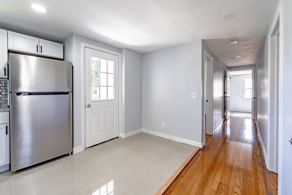 126 Lancaster Avenue West Springfield, MA 01089 - Photo 16 of 35 a view of a kitchen with a refrigerator and wooden floor