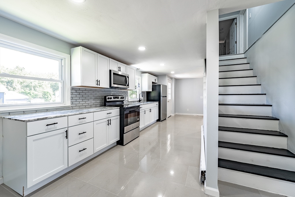 126 Lancaster Avenue West Springfield, MA 01089 - Photo 17 of 35 a kitchen with granite countertop white cabinets and white appliances