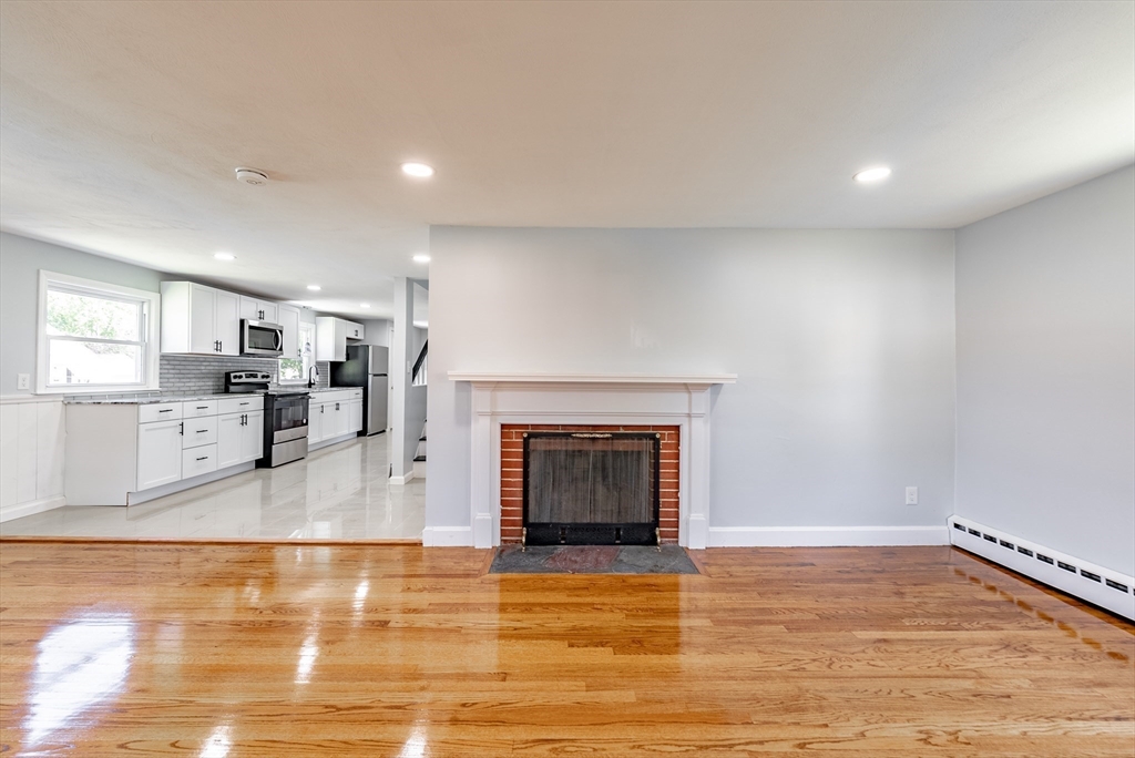 126 Lancaster Avenue West Springfield, MA 01089 - Photo 21 of 35 a view of a living room a kitchen with a fireplace