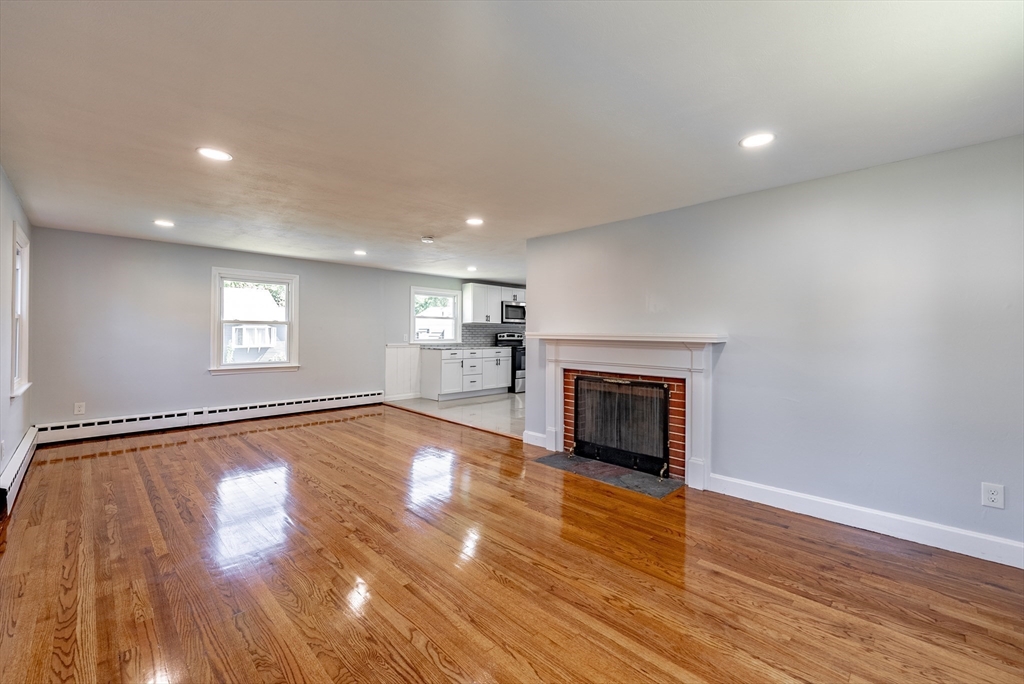 126 Lancaster Avenue West Springfield, MA 01089 - Photo 22 of 35 an empty room with wooden floor fireplace and windows