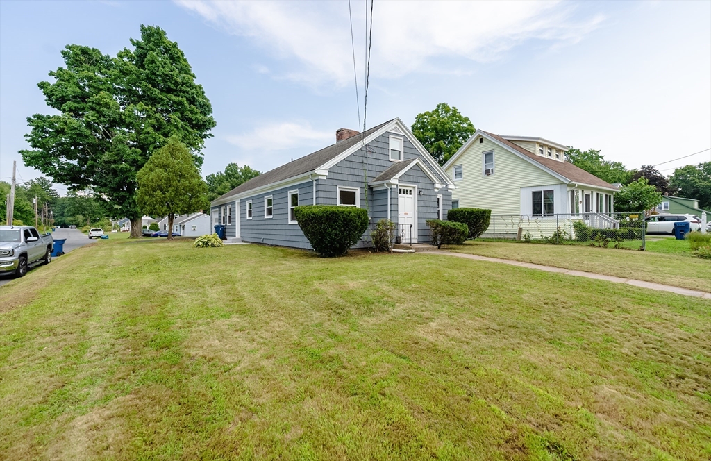 126 Lancaster Avenue West Springfield, MA 01089 - Photo 4 of 35 a view of a house with a big yard and potted plants