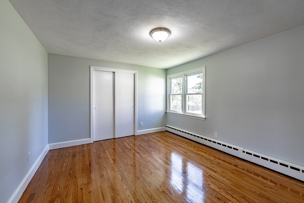 126 Lancaster Avenue West Springfield, MA 01089 - Photo 6 of 35 a view of an empty room with wooden floor and a window