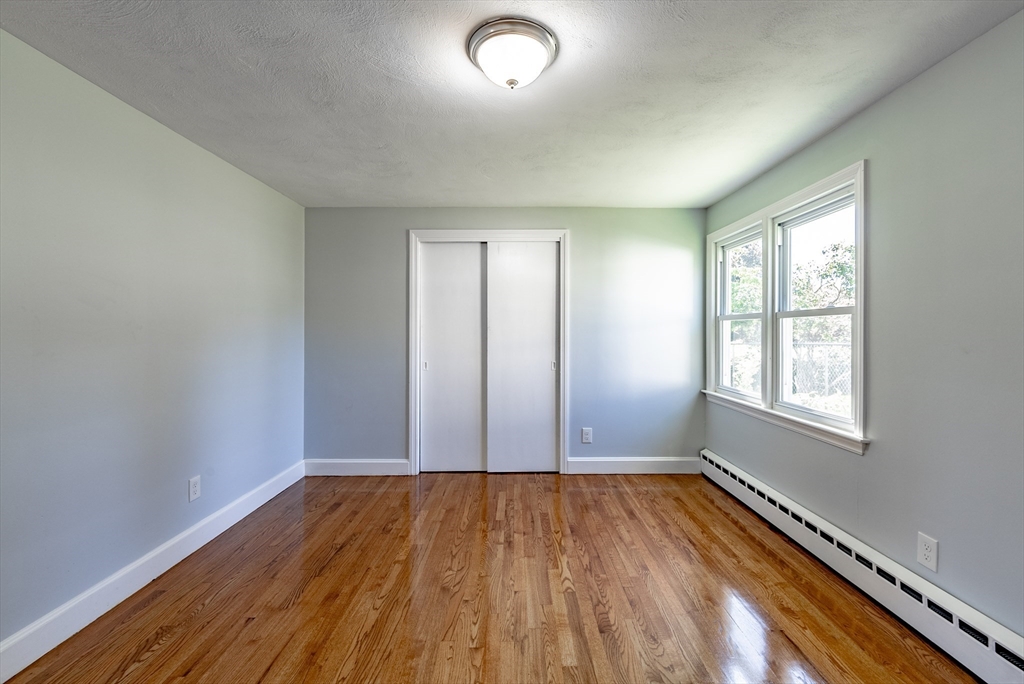 126 Lancaster Avenue West Springfield, MA 01089 - Photo 7 of 35 an empty room with wooden floor and windows