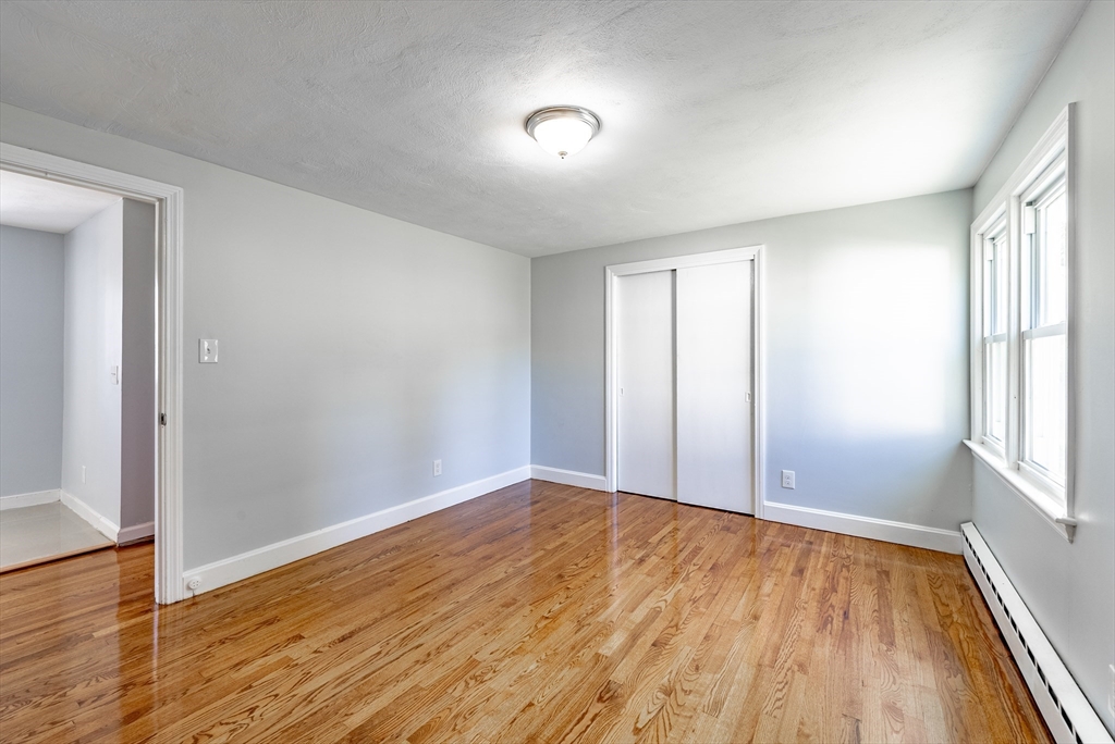 126 Lancaster Avenue West Springfield, MA 01089 - Photo 8 of 35 an empty room with wooden floor and windows