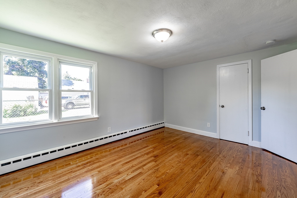 126 Lancaster Avenue West Springfield, MA 01089 - Photo 10 of 35 a view of an empty room with wooden floor and a window