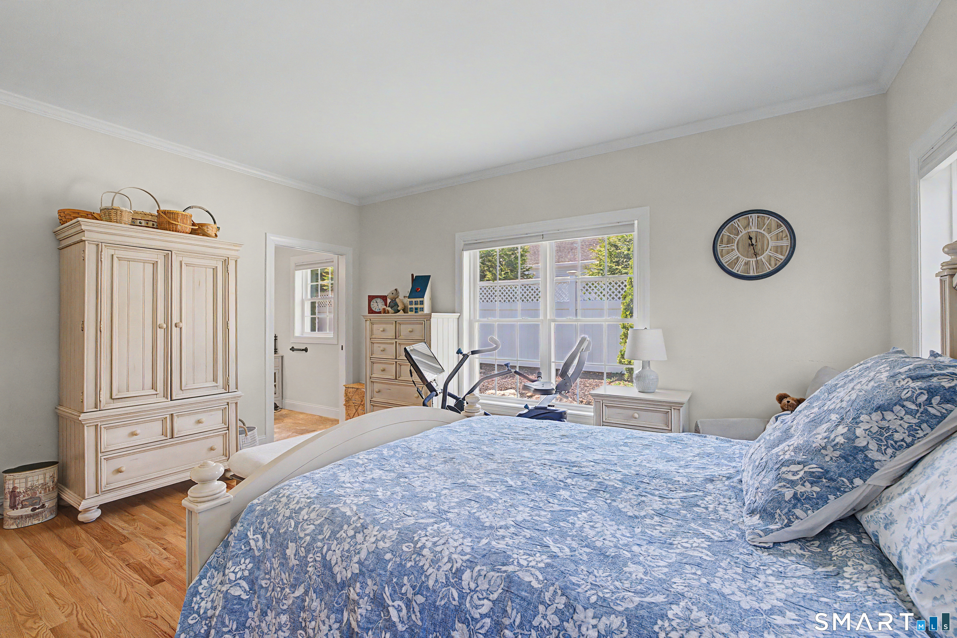 211 Meadowbrook Road, Unit 211 Oxford, CT 06478 - Photo 17 of 38 Bright and inviting first floor primary bedroom filled with natural light, offering a peaceful retreat with views of the yard and easy access to the en suite bath.