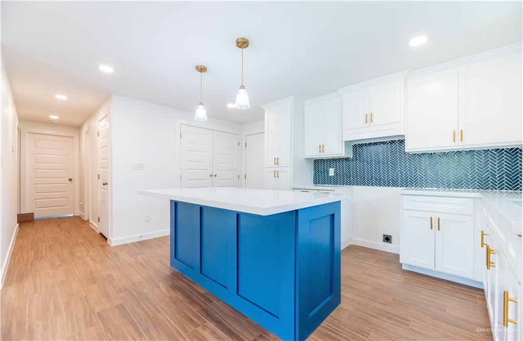 214 South 28th Street McAllen, TX 78501 - Photo 11 of 11 a kitchen with a sink a refrigerator and white cabinets