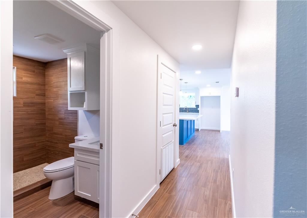 214 South 28th Street McAllen, TX 78501 - Photo 4 of 11 a view of a hallway with wooden floor and a bathroom
