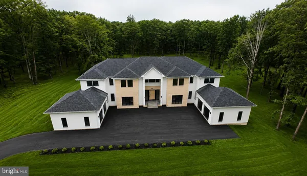 a aerial view of a house with a yard table and chairs