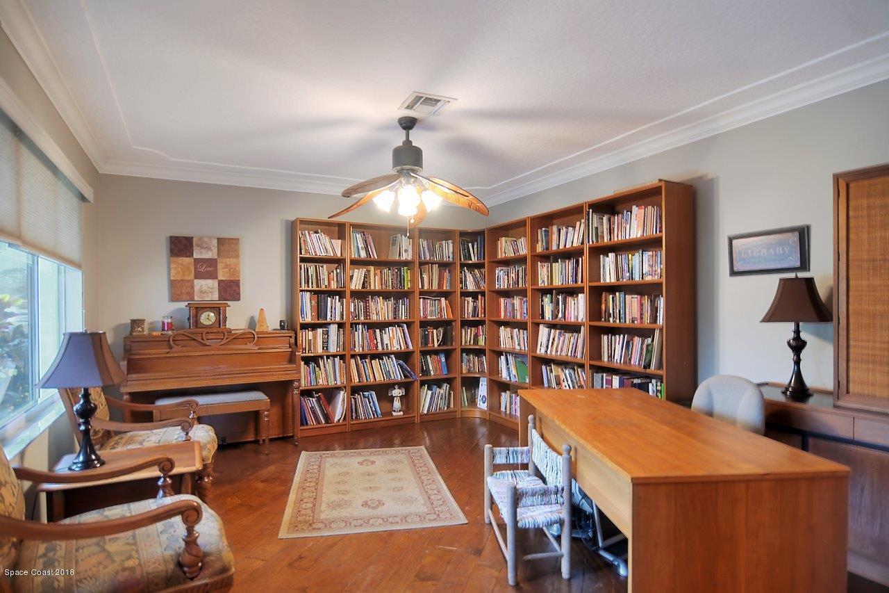 4107 Pinewood Road Melbourne, FL 32934 - Photo 16 of 32 a reading room with furniture and a chandelier