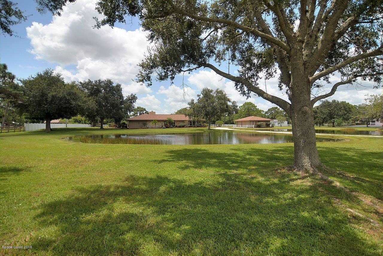 4107 Pinewood Road Melbourne, FL 32934 - Photo 3 of 32 a view of a lake with houses in the background