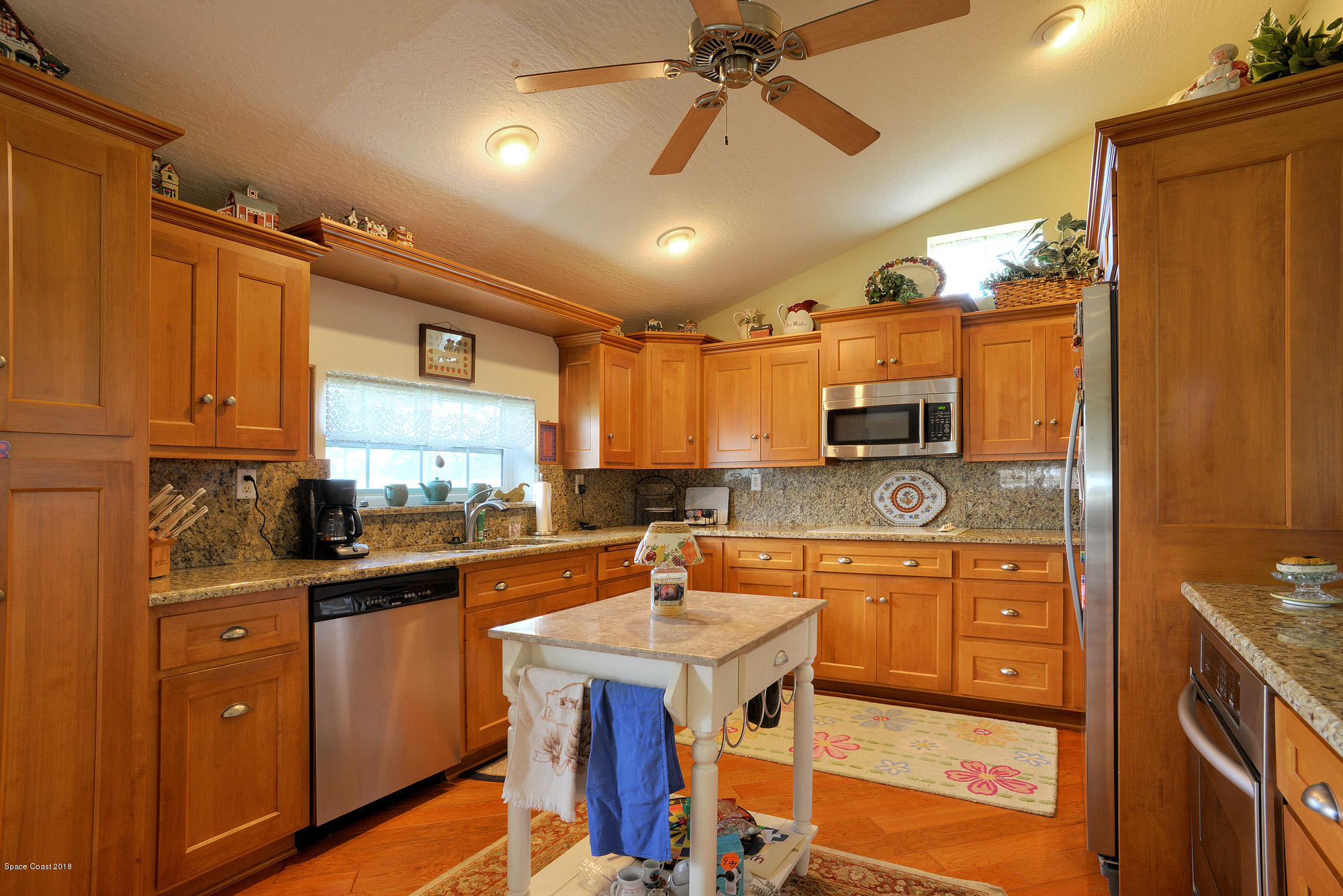 4107 Pinewood Road Melbourne, FL 32934 - Photo 27 of 32 a kitchen with stainless steel appliances a sink stove and refrigerator