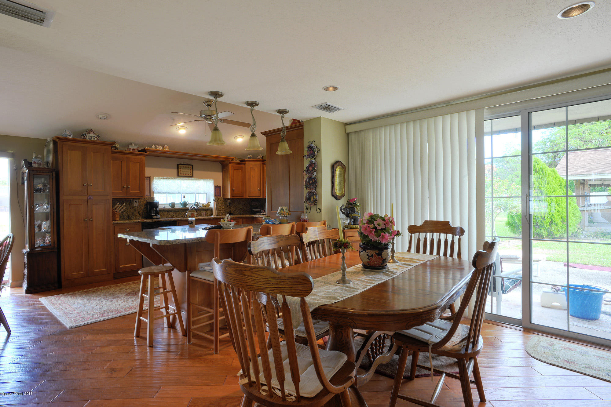 4107 Pinewood Road Melbourne, FL 32934 - Photo 32 of 32 a view of a dining room with furniture window and wooden floor