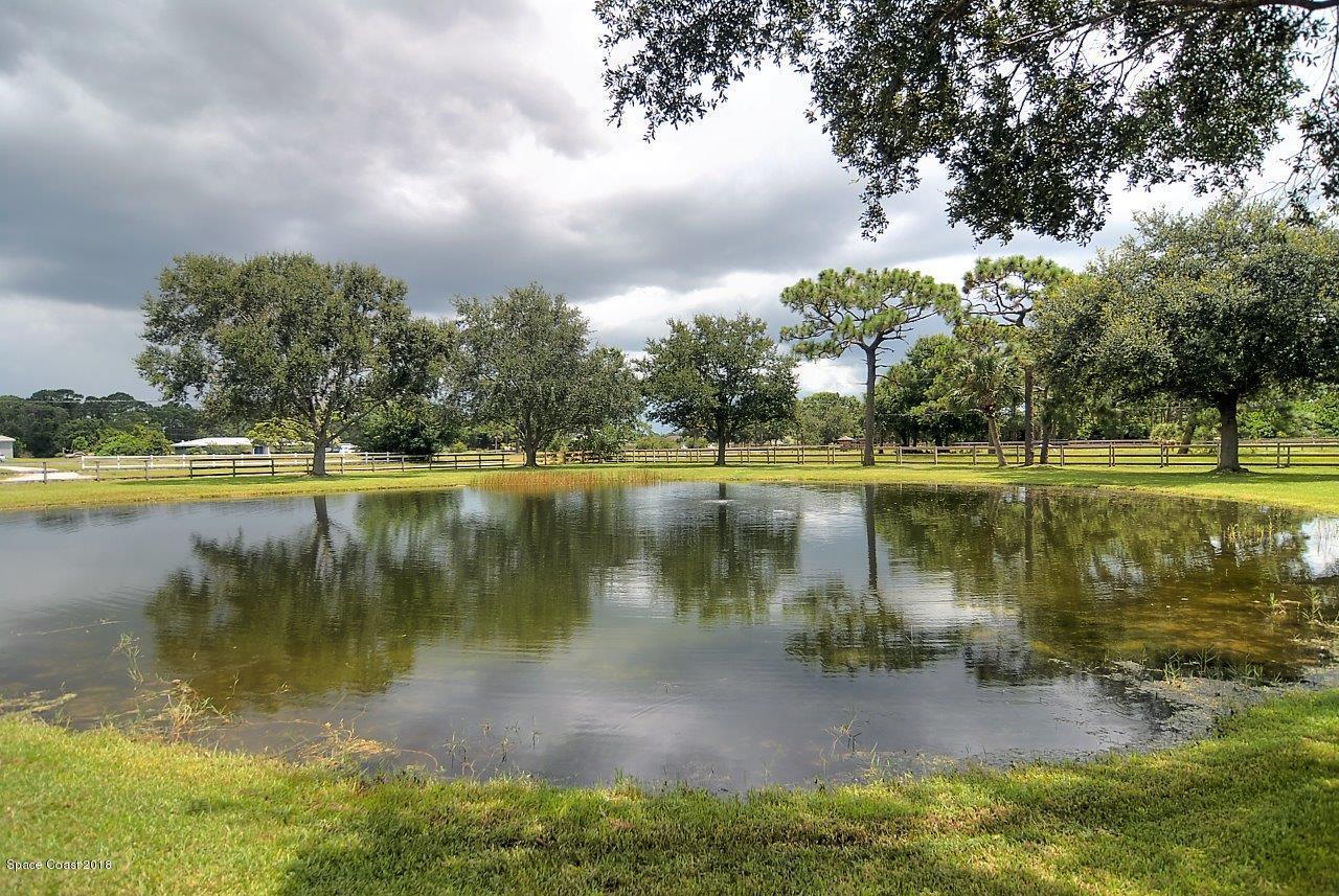 4107 Pinewood Road Melbourne, FL 32934 - Photo 5 of 32 a view of a lake with houses in the back